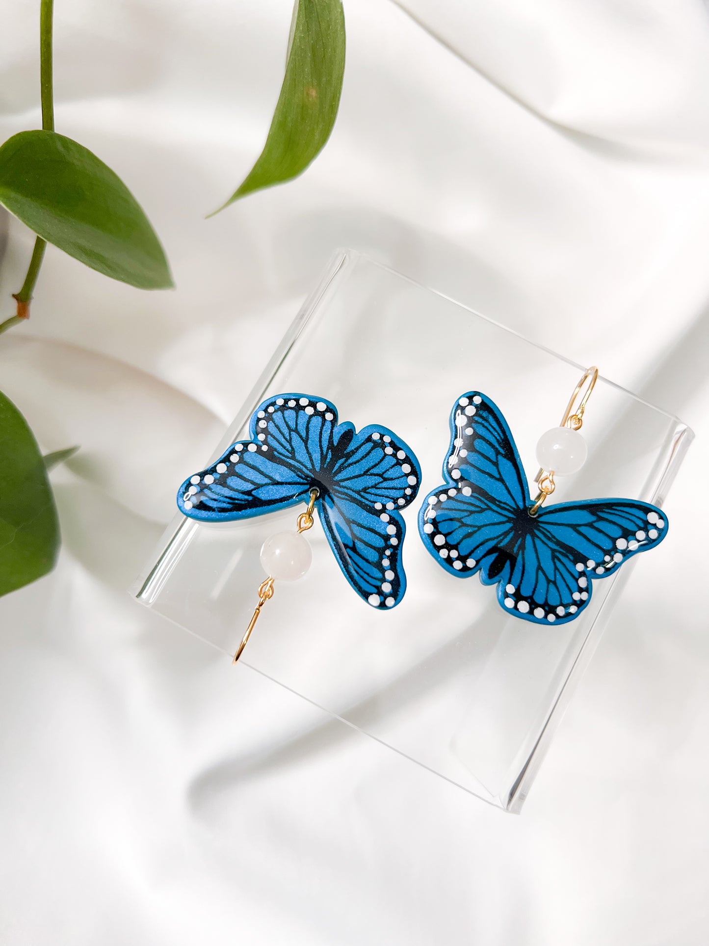 Handmade blue monarch butterfly earrings by ReynaBee Clay Co